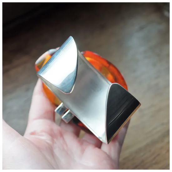 Metallic object held in a hand with a blurred background