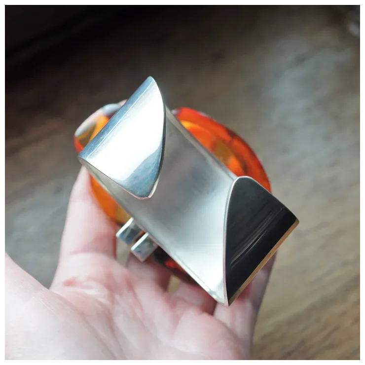 Metallic object held in a hand with a blurred background