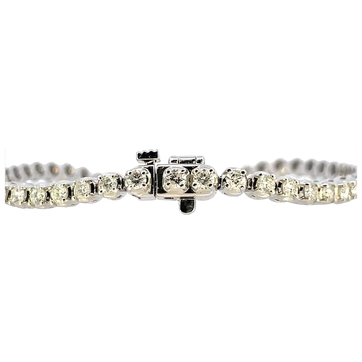 Silver bracelet with clear gemstones on a white background
