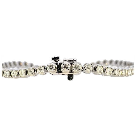 Silver bracelet with clear gemstones on a white background