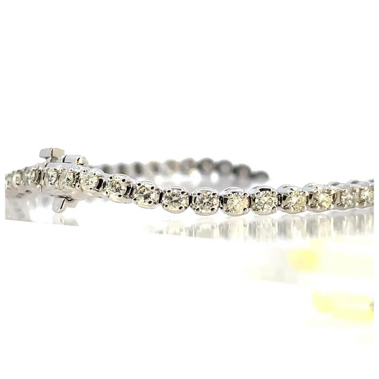 Silver bracelet with clear stones on a white background