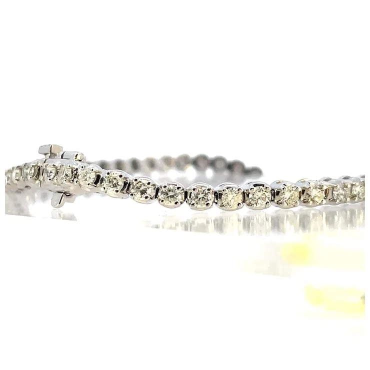Silver bracelet with clear stones on a white background