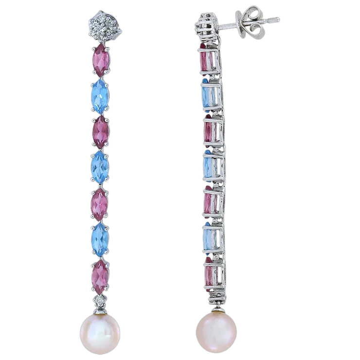 Pair of earrings with gemstones and pearls on a white background