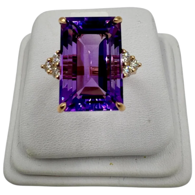 Ring with purple gemstone and gold accents on a white background