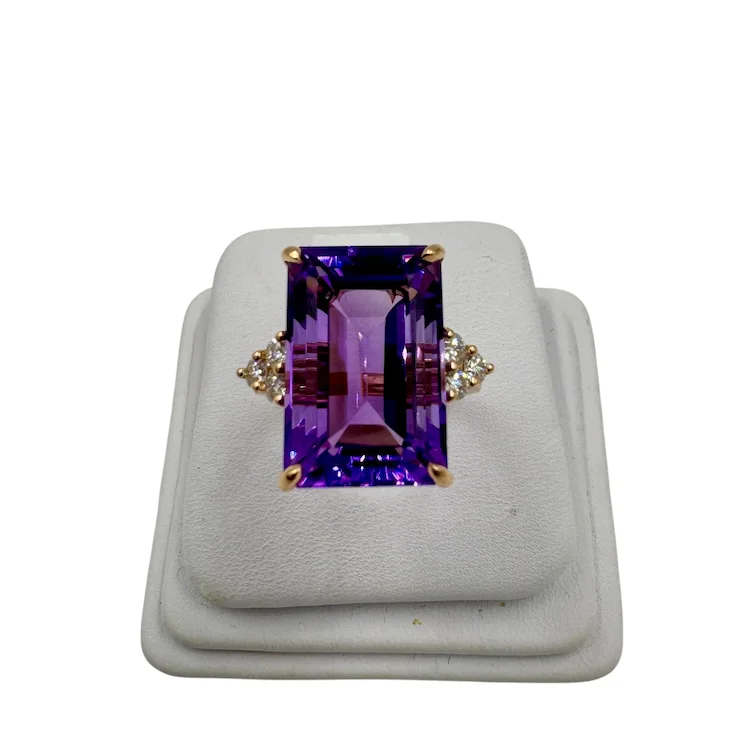 Purple gemstone ring on a white background