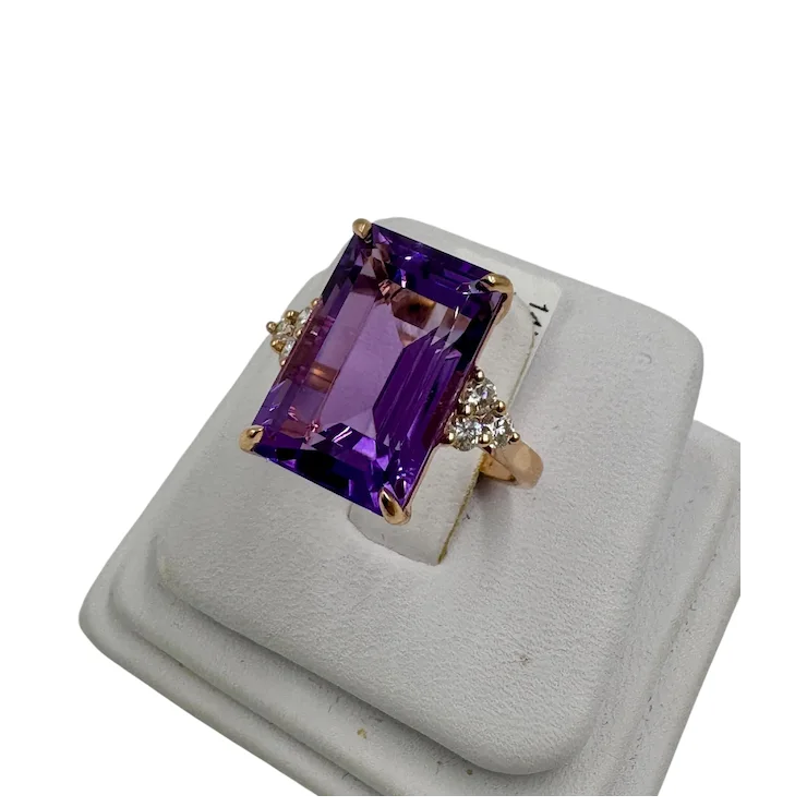 Ring with a purple gemstone on a white background