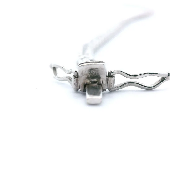 Metallic clip with a white cord on a white background