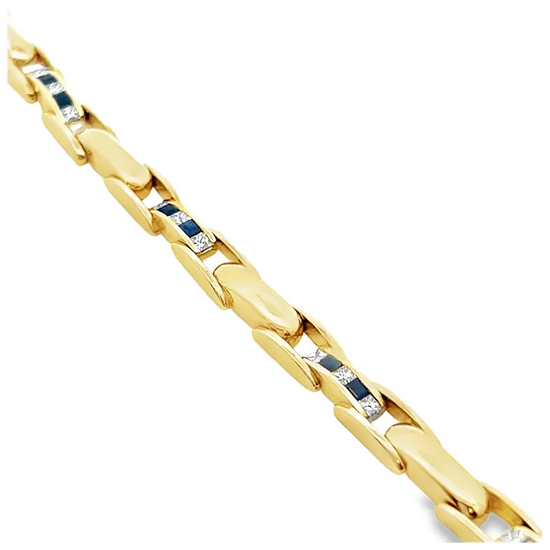 Gold bracelet with embedded blue stones on a white background