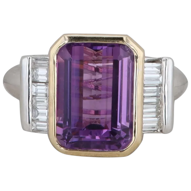 Ring with a purple gemstone and silver accents on a white background