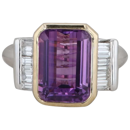 Ring with a purple gemstone and silver accents on a white background