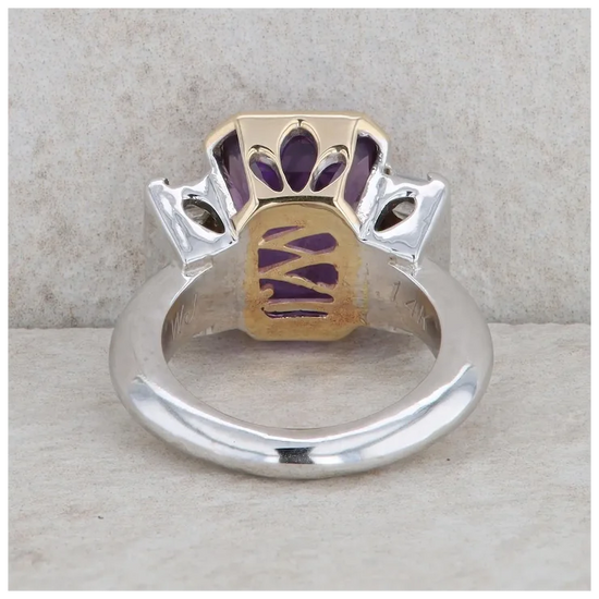 Ring with gold and silver design on a textured surface