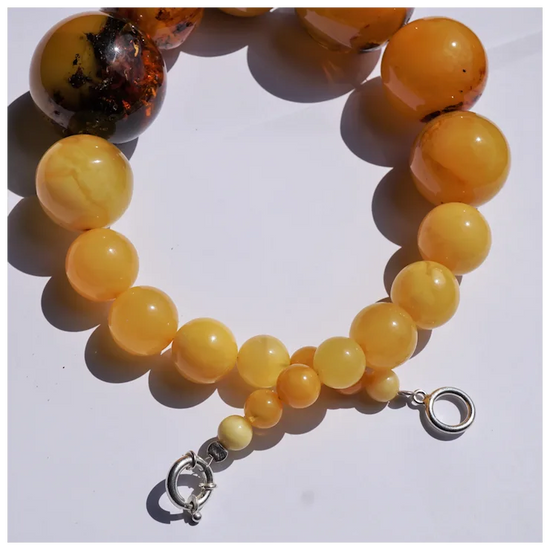 Beaded bracelet with yellow and brown beads on a white background