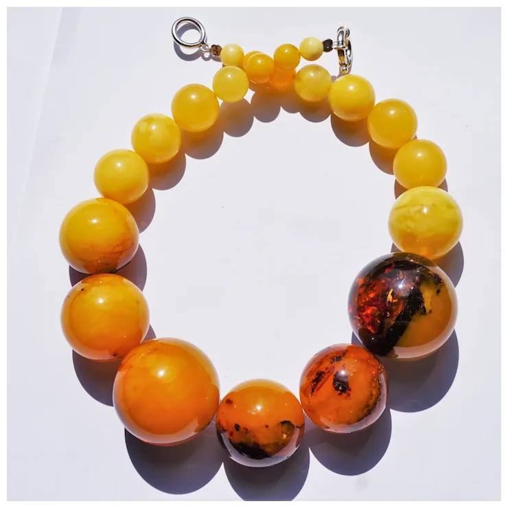 Necklace with large amber-colored beads on a white background