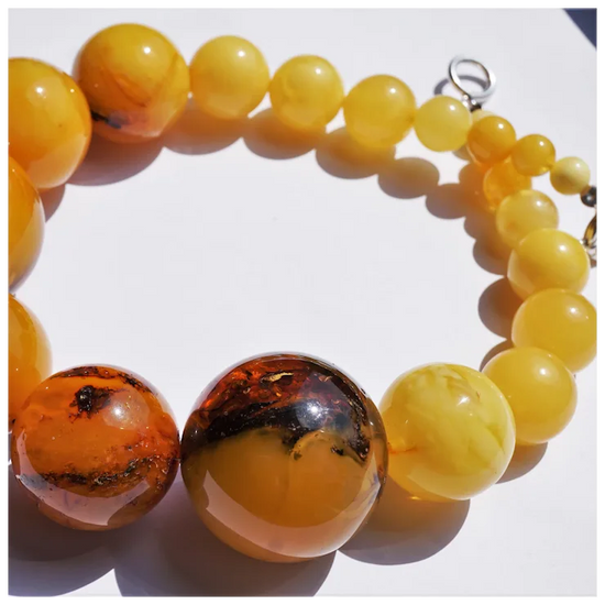 Beaded bracelet with yellow and brown beads on a white background
