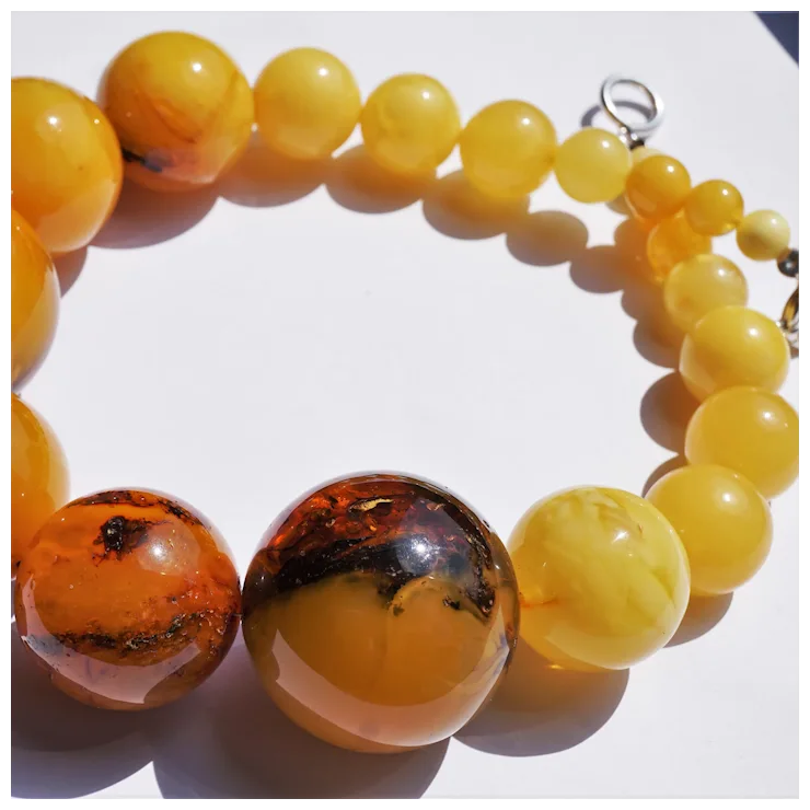 Beaded bracelet with yellow and brown beads on a white background