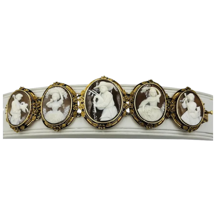 Bracelet with oval cameo stones featuring classical figures on a white background