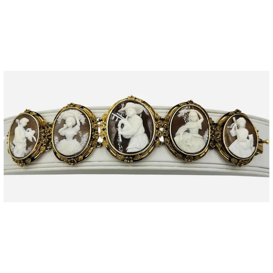 Bracelet with gold and cameo stones on a white background
