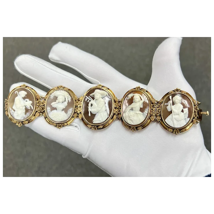 Vintage-style bracelet with cameo stones on a mannequin hand against a neutral background
