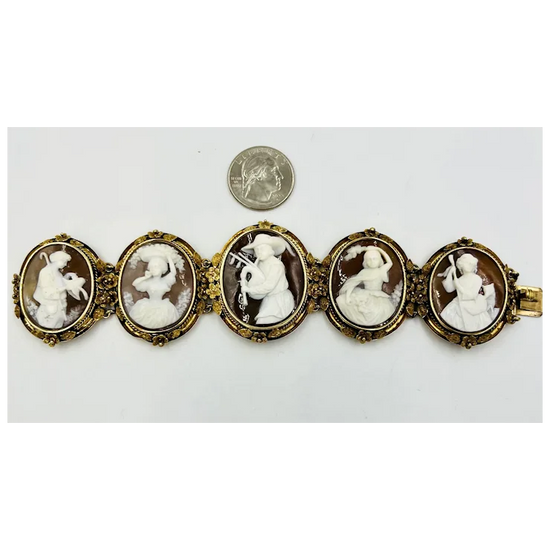 Bracelet with cameo stones next to a quarter for scale on a white background