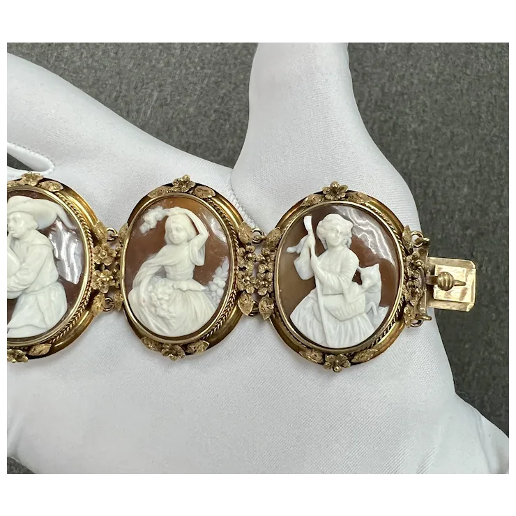 Vintage-style bracelet with three cameo stones on a mannequin arm against a gray background