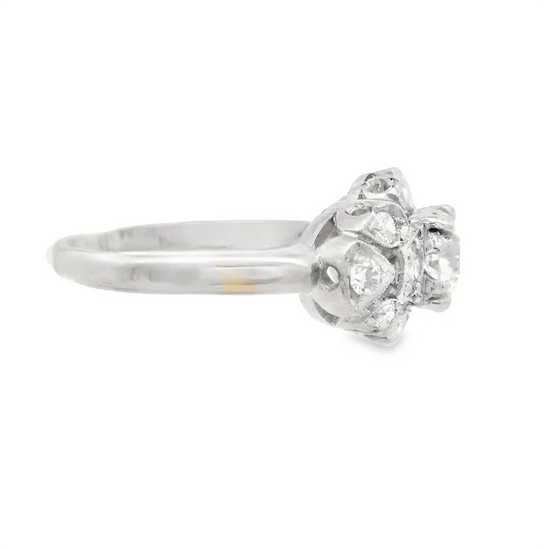 Silver ring with a diamond cluster on a white background