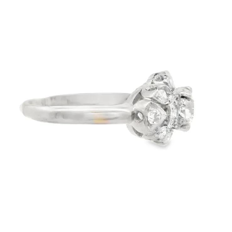 Silver ring with a diamond cluster on a white background