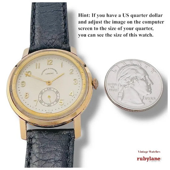 Vintage watch with black leather strap and gold case next to a US quarter dollar for size comparison, with Rubylane branding.
