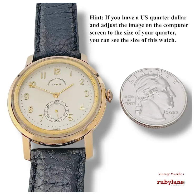 Vintage watch with black leather strap and gold case next to a US quarter dollar for size comparison, with Rubylane branding.