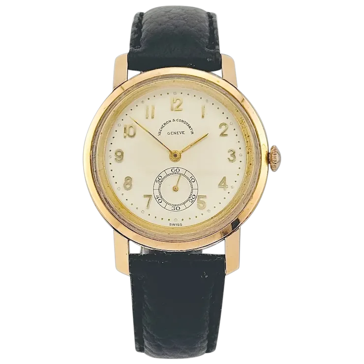 Gold watch with black leather strap on a white background
