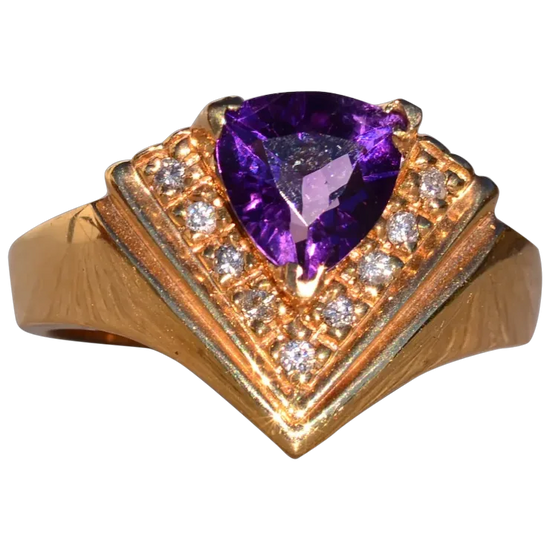 Gold ring with a purple gemstone and smaller diamonds on a white background