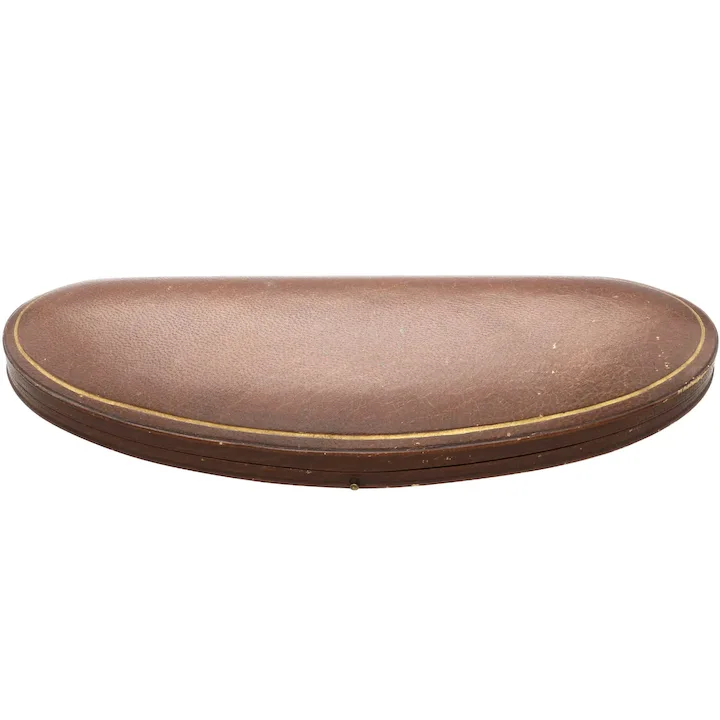 Round brown leather ottoman on a white background