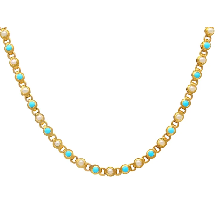 Necklace with pearls and turquoise stones on a white background
