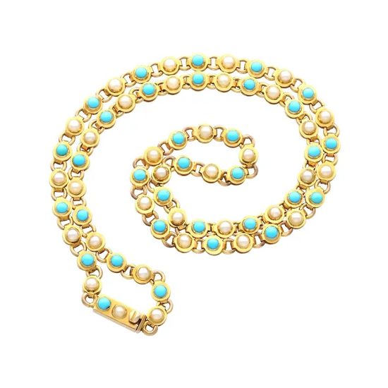 Gold necklace with pearls and turquoise stones on a white background