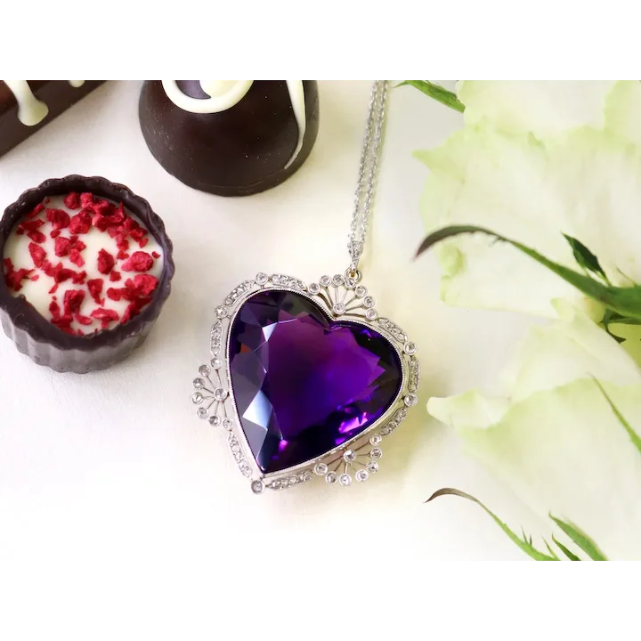 Heart-shaped purple pendant on a chain with a floral background