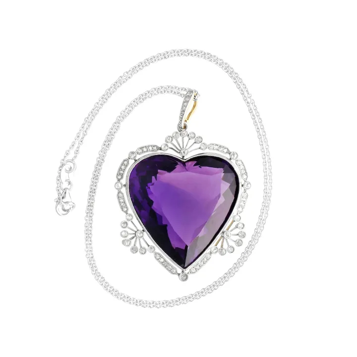 Heart-shaped purple pendant on a silver chain against a white background