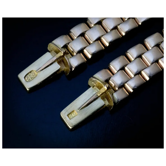 Close-up of a gold and white bracelet on a dark background
