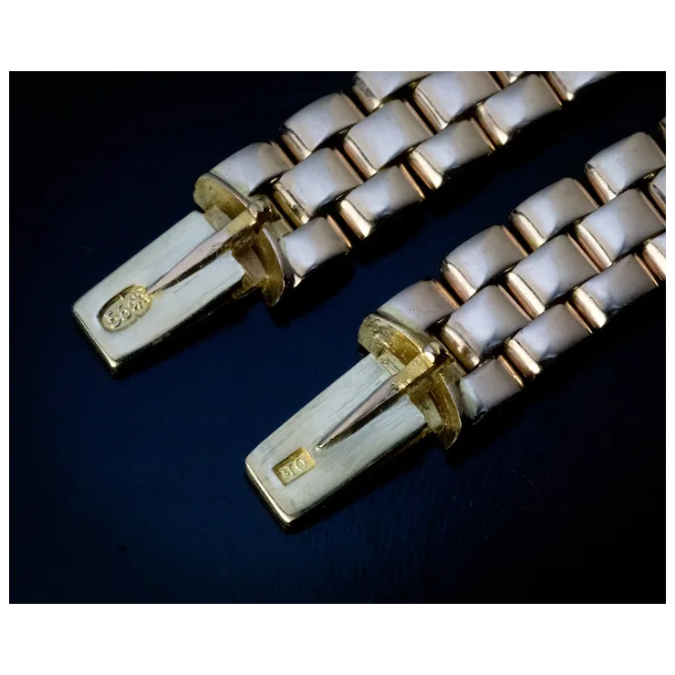 Close-up of a gold and white bracelet on a dark background