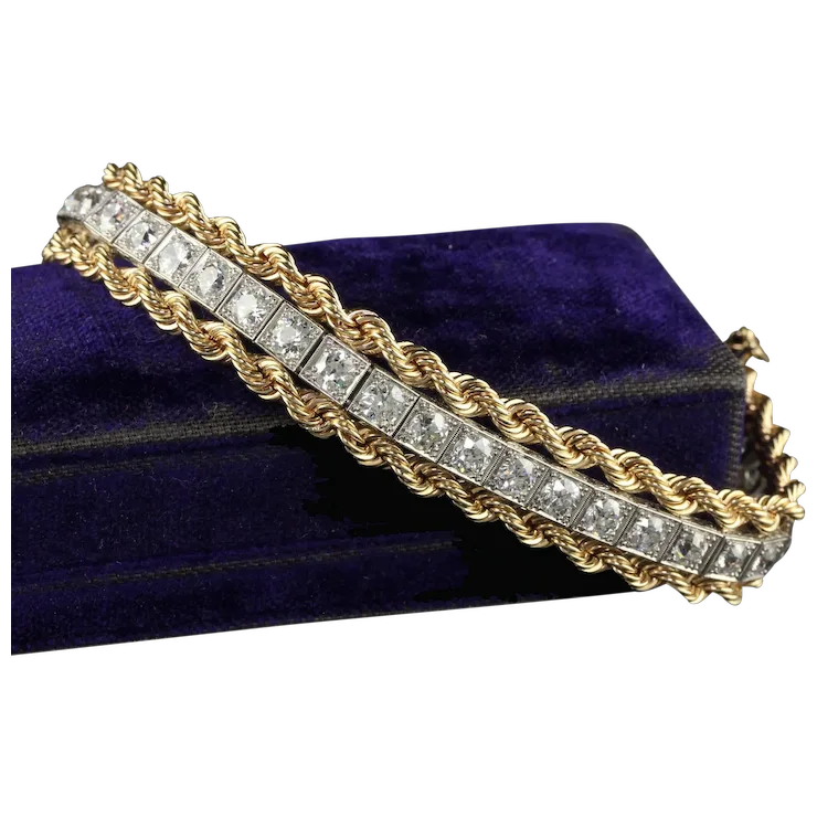 Gold and diamond bracelet on a blue velvet cushion