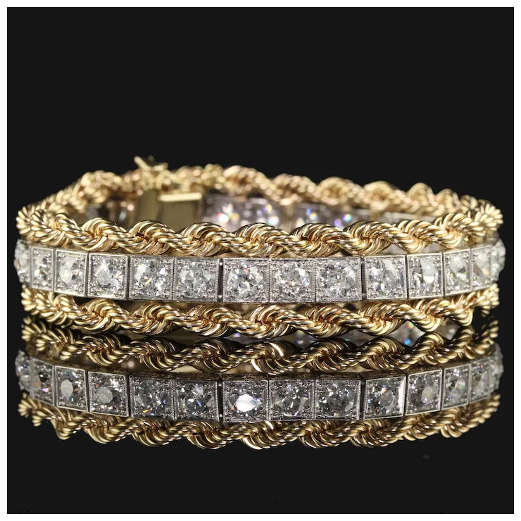 Gold bracelet with diamond accents on a black background