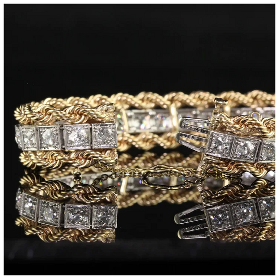 Gold and silver bracelet with diamond accents on a reflective surface