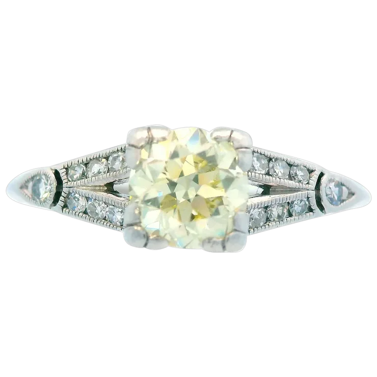 Diamond ring with a yellow gemstone on a white background