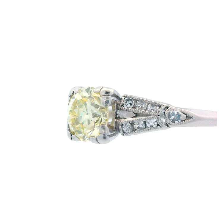Diamond ring with a yellow gemstone on a white background
