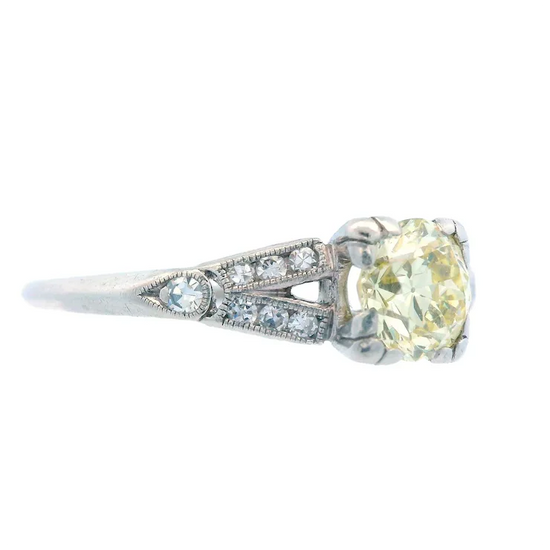 Diamond ring with a yellow gemstone on a white background