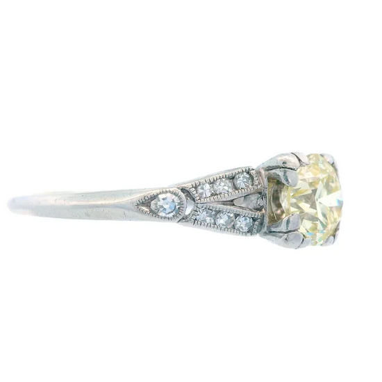 Diamond ring with a yellow gemstone on a white background
