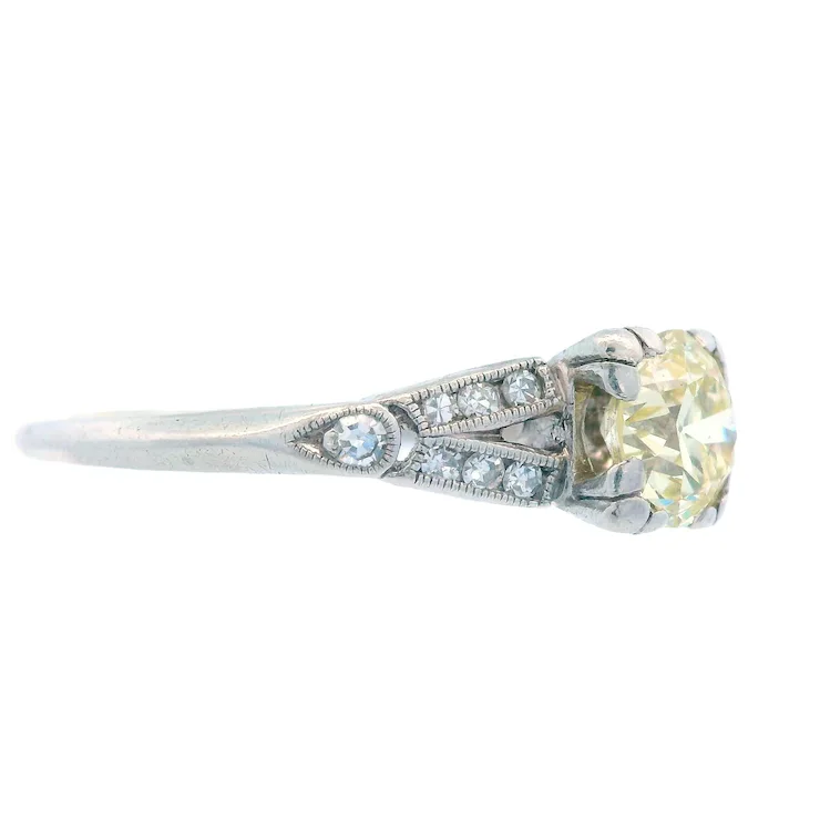 Diamond ring with a yellow gemstone on a white background