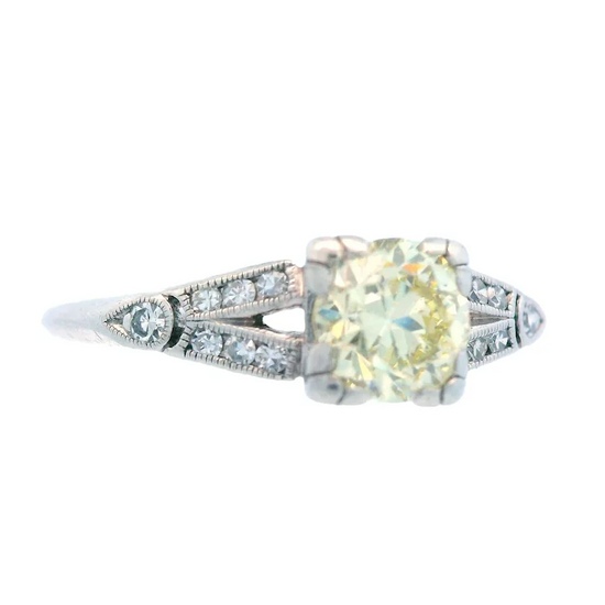 Diamond ring with a yellow gemstone on a white background