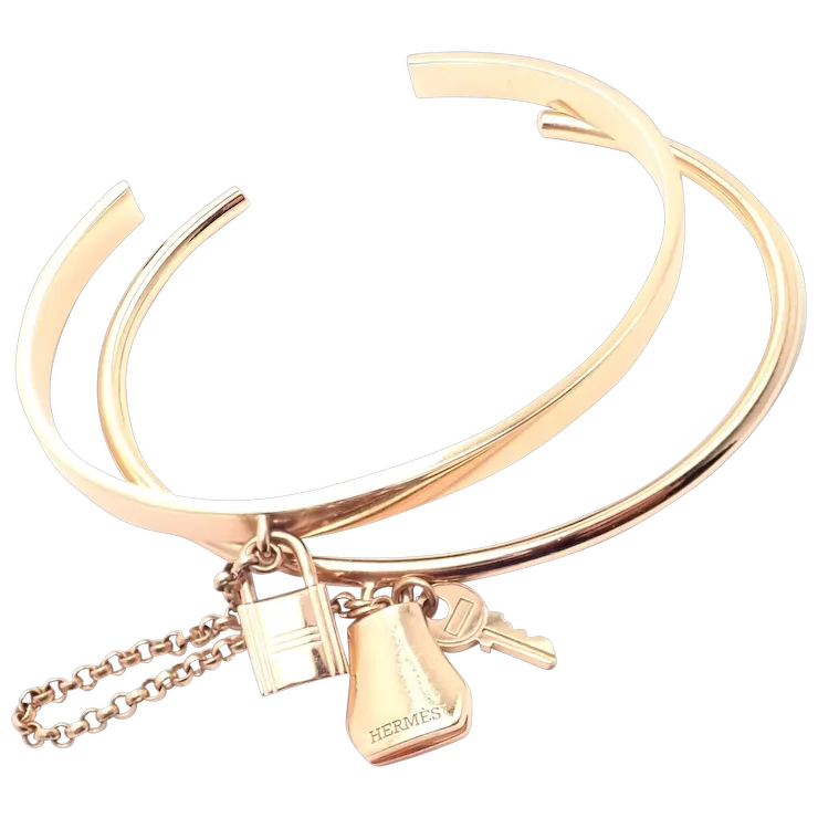 Gold bracelet with charms on a white background