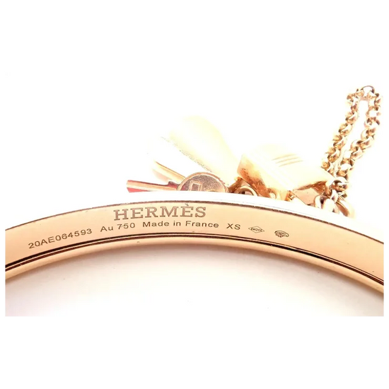 Rose gold Hermès bracelet on a white background