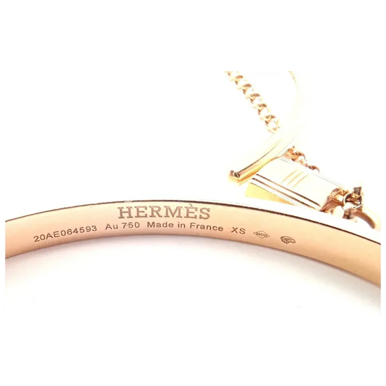 Rose gold Hermes bracelet on a white background