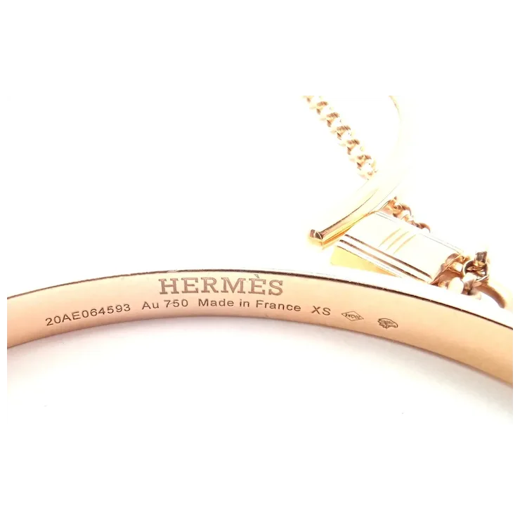 Rose gold Hermes bracelet on a white background